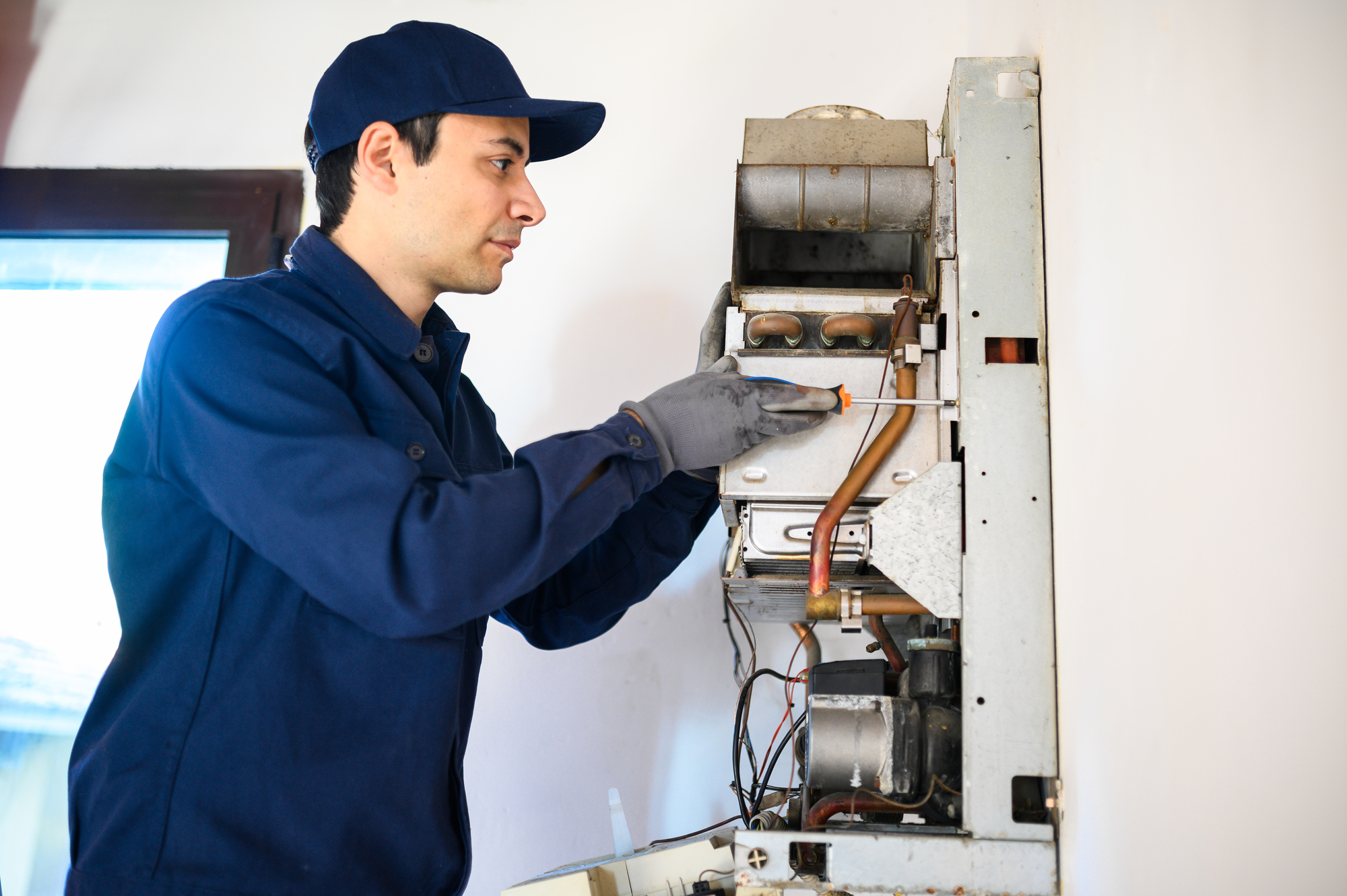Technician Repairing An Hot-Water Heater
